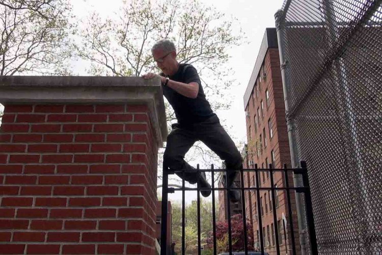 Jay Rosenblatt wearing all-black climbing his school’s fence.  From Jay Rosenblatt’s ‘When We Were Bullies.’ Courtesy of HBO. 