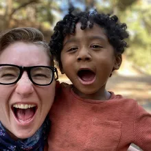 Filmmaker Nico Opper and their baby, Jonah making faces at the camera. Opper is wearing black-rimmed glasses and Jonah, an orange shirt. Courtesy of Nico Opper.